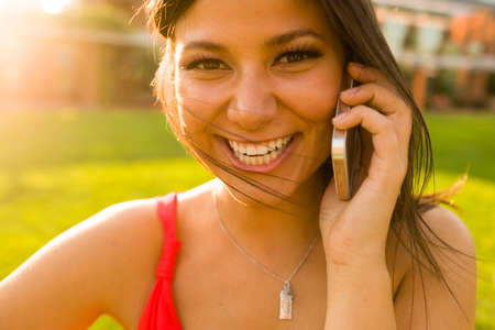 Portrait of young woman chatting on smartphoneの写真素材