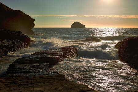View of rocky cliffs and sea at sunrise, Treknow, Cornwall, UK