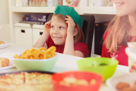 Children wearing paper crowns at christmasの写真素材