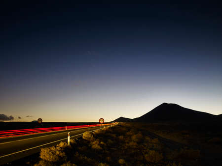 Highway taillight trails at dawn, Lanzarote, Spain