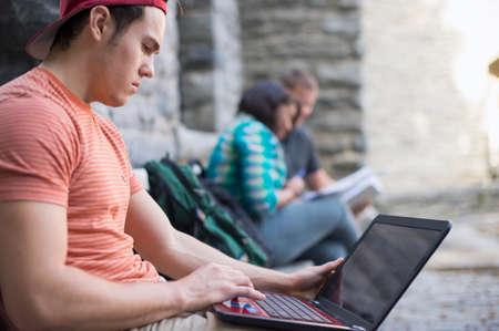 Male student using laptopの写真素材