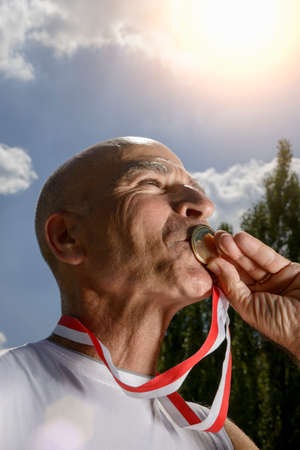 Sportsman kissing medalの写真素材