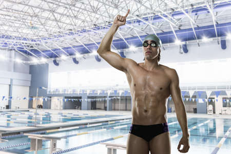 Male swimmer with arm raisedの写真素材