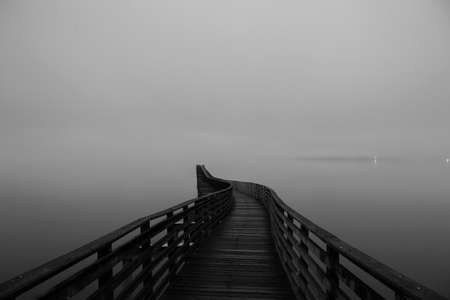 View of winding wooden pier over misty Puget Sound, Seattle, Washington State, USAの写真素材