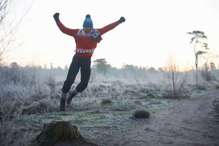 Man jumping in rural winter sceneの写真素材