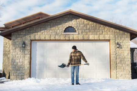 Man shoveling snow, Young's Point, Ontario, Canadaの写真素材