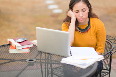 Women working, reading and using laptop outdoors