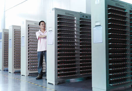 Worker looking at product in ecigarette factoryの写真素材