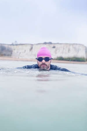 Mature man swimming in the seaの写真素材
