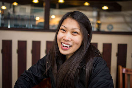 Portrait of smiling young woman in cafe, Seattle, Washington State, USA