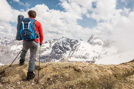 Young man looking at view in Bavarian Alps, Oberstdorf, Bavaria, Germanyの写真素材