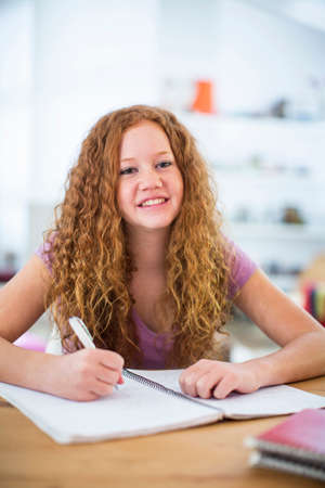 Teenage girl writing notesの写真素材