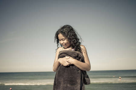 Girl wrapped in towel on beach, Truro, Massachusetts, Cape Cod, USAの写真素材