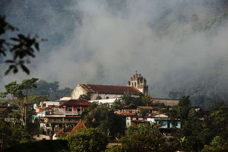 View of mountain village in mist, Lanquin, Alta Verapaz, Guatemala, Central America