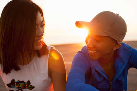 Two young women outdoors, smiling