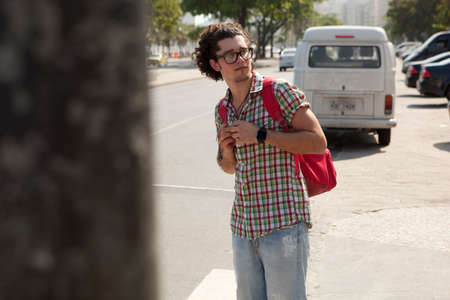 Young male tourist looking over his shoulder, Copacabana, Rio De Janeiro, Brazil