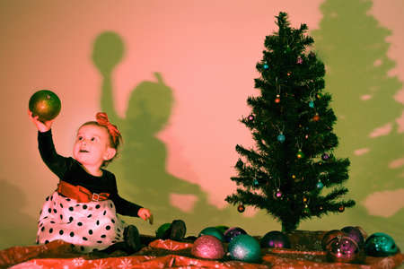 Little girl holding a christmas baubleの写真素材