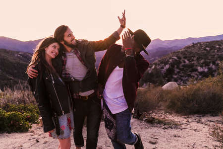Three adult friends on desert road trip, Los Angeles, California, USAの写真素材