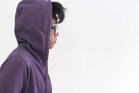 profile of woman wearing hoodie and glasses in studioの写真素材