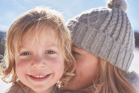 Mother and son enjoying day out in snowの写真素材