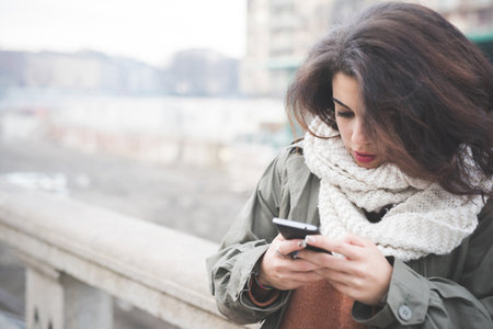 Young woman texting on smartphoneの写真素材