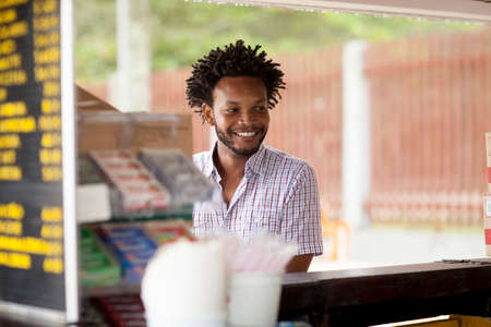 Mid adult man at beach bar,  Ipanema beach, Rio De Janeiro, Brazilの写真素材