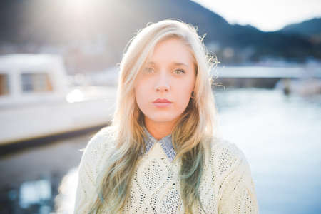 Portrait of young woman on lakeside, Lake Como, Italy