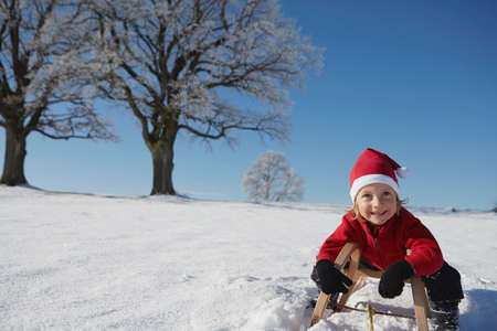 Portrait of young boy on sled