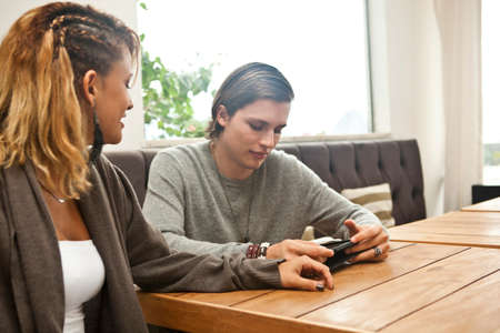 Young couple using digital tablet in hotel lobby