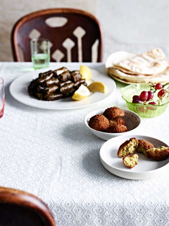 Still life with flatbreads, vine leaves and grapes