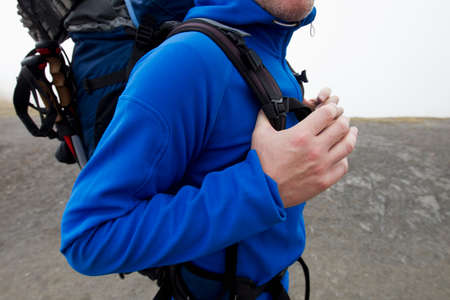 Close up of male hiker carrying backpack, Kleine Scheidegg, Grindelwald, Switzerland