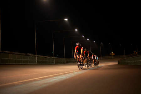Cyclists cycling on track at velodrome, outdoorsの写真素材