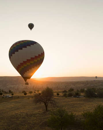 Two silhouetted hot air balloons at sunset, Cappadocia, Anatolia,Turkeyの写真素材