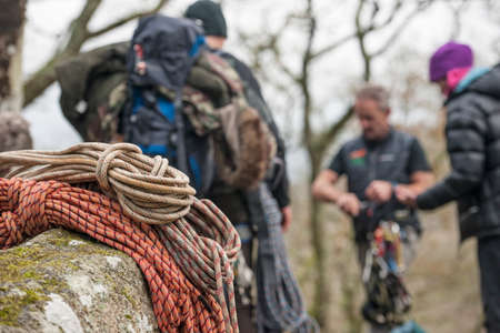 Climbing ropes on rocks with climbers in backgroundの写真素材