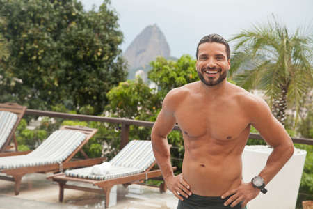 Man by poolside, Sugarloaf Mountain in background, RIo, Brazilの写真素材