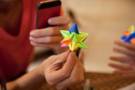 Students playing origami paper game