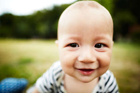 Close up portrait of baby boy smiling at camera