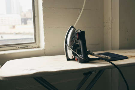 Iron and ironing board in fashion studioの写真素材