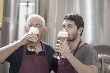 Two brewers drinking beer in the brewery