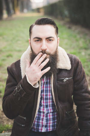 Young bearded man in park, Milan, Italyの写真素材