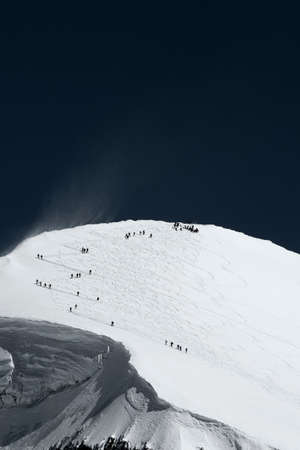 Skiers on mountain in distance, Zermatt, Valais, Switzerland