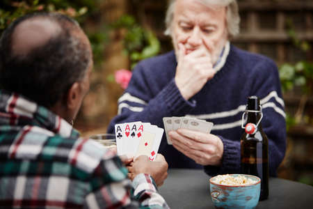 Two senior men playing cardsの写真素材