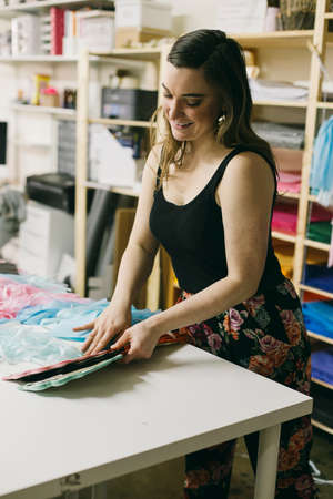 Female textile designer matching textiles in design studioの写真素材