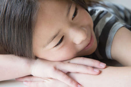 Close up of girl resting on handsの写真素材