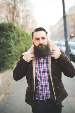 Young bearded man on pavementの写真素材