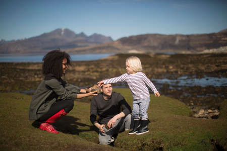 Mother showing son rock, Isle of Skye, Hebrides, Scotlandの写真素材