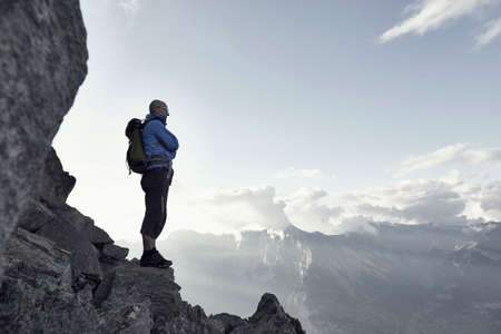 Mature man standing on rocks, Valais, Switzerland