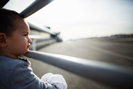 Boy looking out between railingsの写真素材
