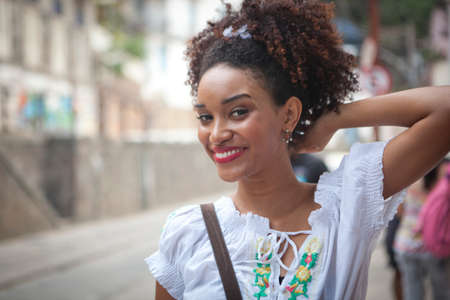 Portrait of young woman, looking at camera, smiling