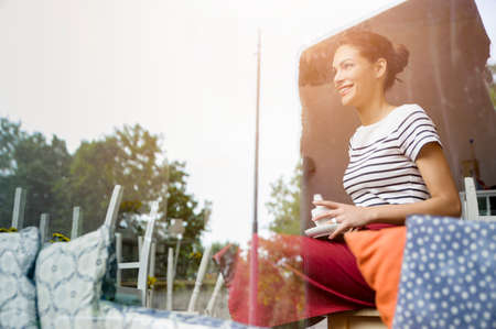 Waitress taking break in cafeの写真素材